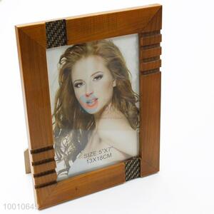 Wooden photo frame with carved pattern