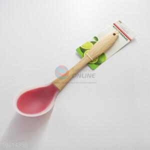 Silicone kitchen <em>spoon</em> with <em>wood</em> handle