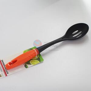 Leakage spoon with orange plastic handle