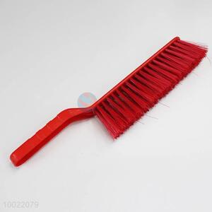 Red long hair cleaning <em>brush</em> with plastic handle
