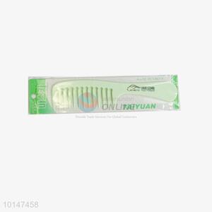 Green plastic hair comb with wide tooth